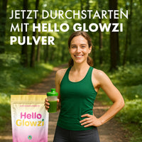 Thumbnail for Frau im Wald hält grünen Shaker neben Hello Glowzi Beutel und Text zu Hello Glowzi Pulver oben