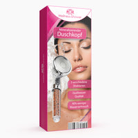 Thumbnail for Verpackung in Pink mit Bild eines silbernen Duschkopfs mit Mineralsteinen und Frau mit Wasser im Gesicht